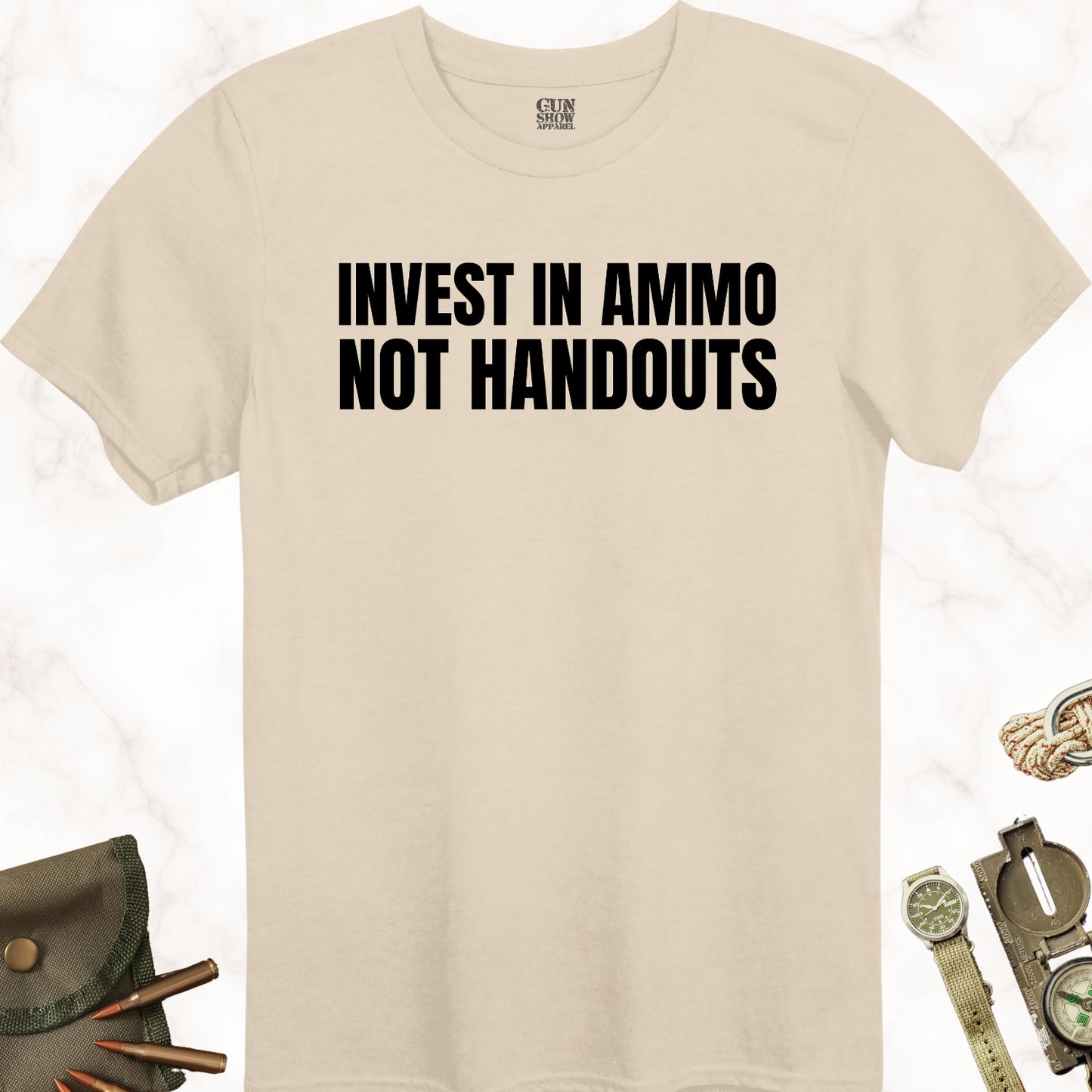 Invest In Ammo Not Handouts T-Shirt in color Sand with black design from Gun Show Apparel